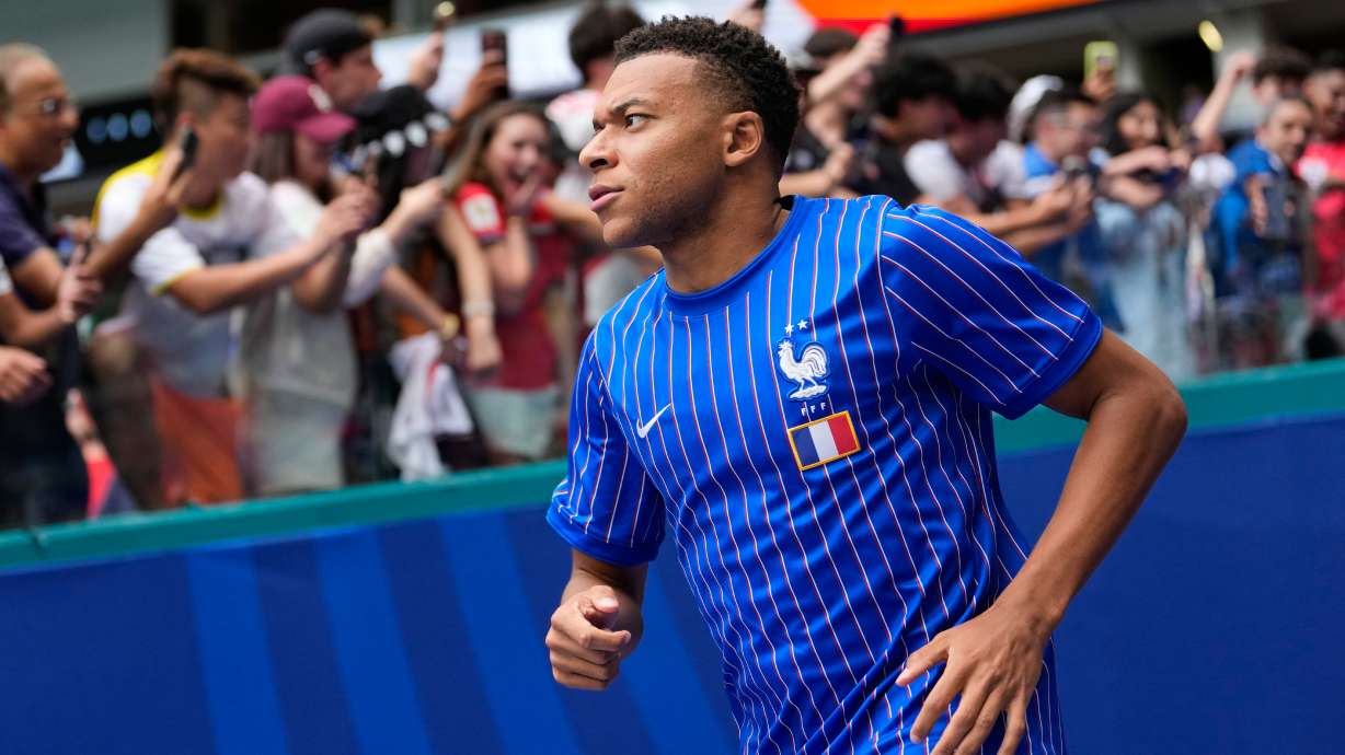 France's Kylian Mbappe jogs onto the field for warmups before the World Cup third-place playoff soccer match between France and England in Miami Gardens, Fla., Saturday, July 18, 2026.