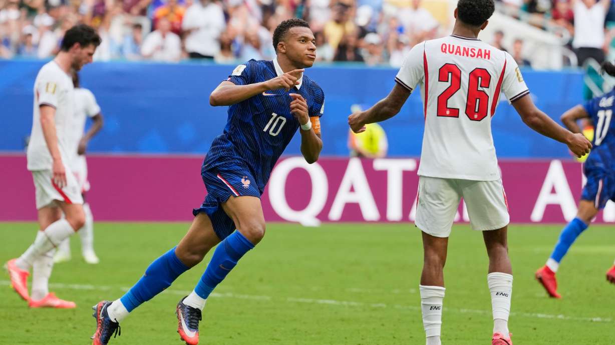 France's Kylian Mbappe (10) celebrates scoring his side's third goal as England's Jarell Quansah (26) reacts to the score during the World Cup third-place playoff soccer match between France and England in Miami Gardens, Fla., Saturday, July 18, 2026.