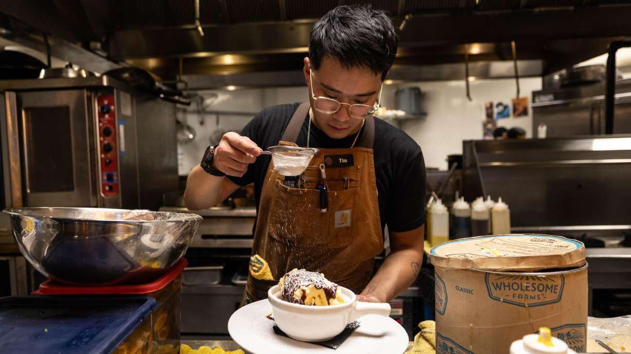 Drunken Kitchen owner and chef Tim Rammell tops a smoked sea salt brownie with powdered sugar at Drunken Kitchen in Salt Lake City on Tuesday.