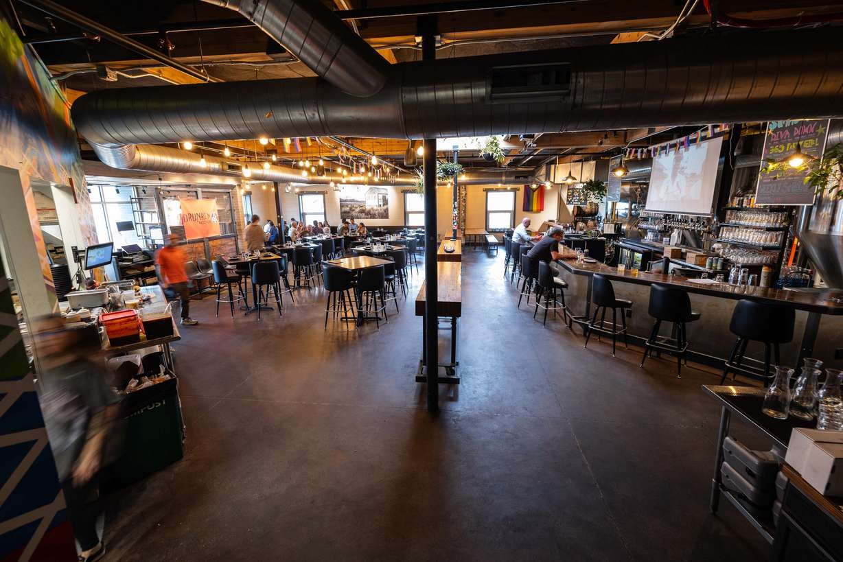 Workers deliver food to hungry customers at Drunken Kitchen in Salt Lake City on Tuesday.
