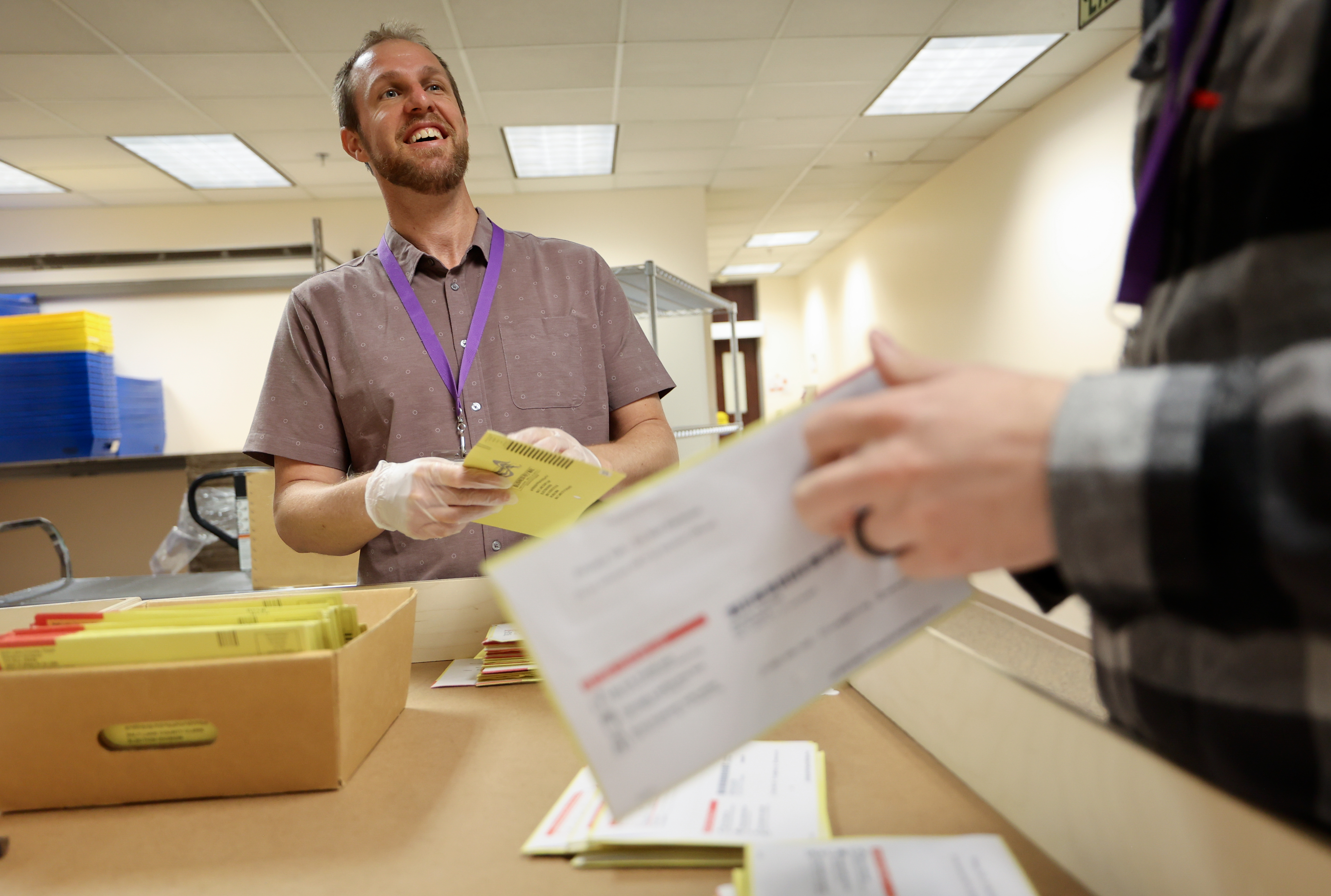 Timothy Schorzman, Salt Lake County Clerk’s Office elections asset manager, tabs primary election ballot envelopes to expose signatures at the Salt Lake County Government Center in Salt Lake City on Monday, June 24, 2024.
