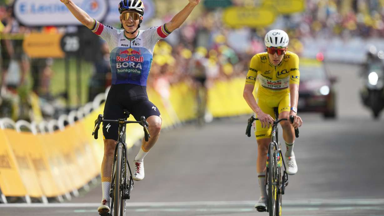 Belgium's Remco Evenepoel celebrates as he crosses the finish line ahead Slovenia's Tadej Pogacar to win the fifteenth stage of the Tour de France cycling race, from Champagnole to the Plateau de Solaison, France, Sunday, July 19, 2026.