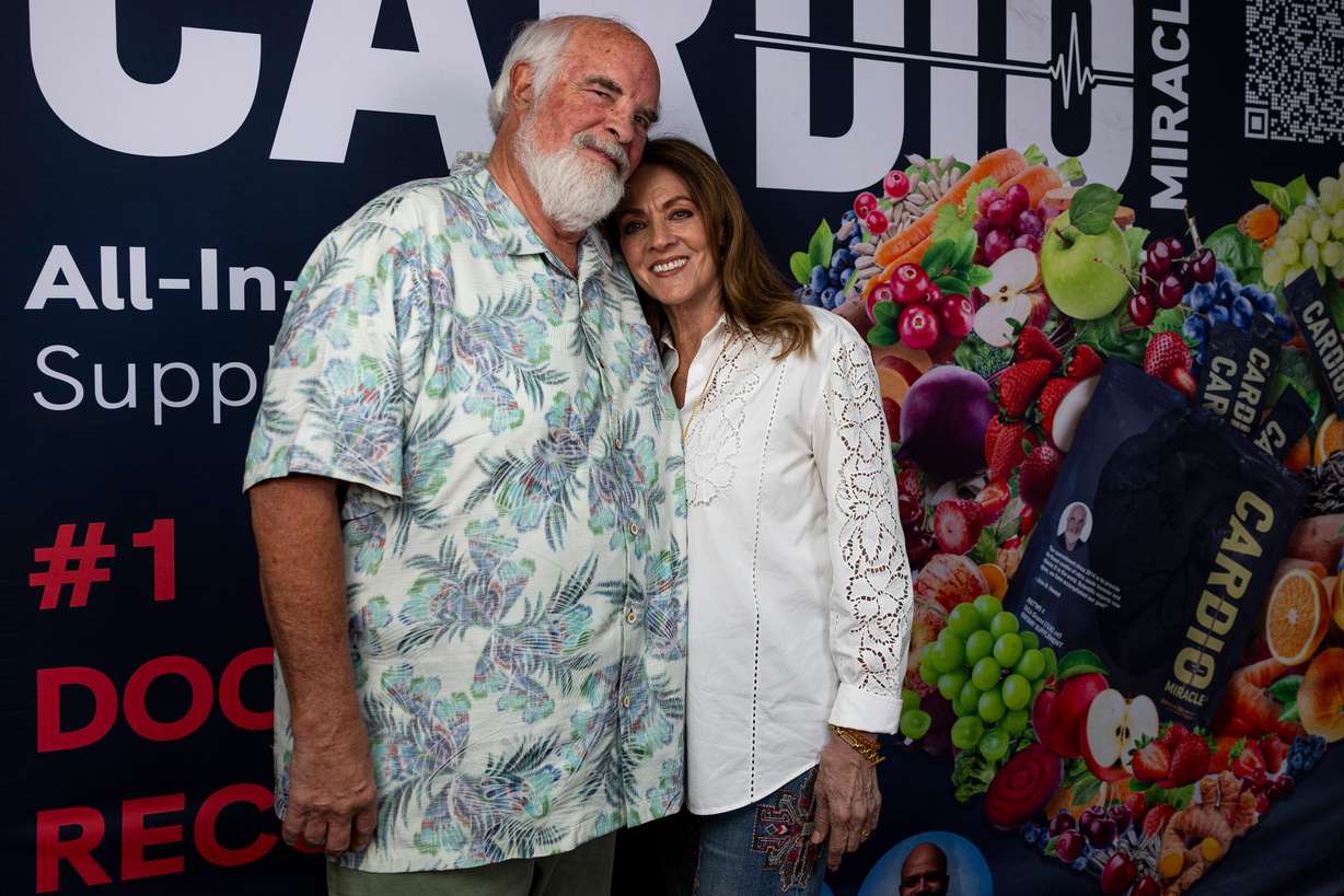 Cardio Miracle founder John Hewlett, left, and his wife, Janet, right, pose for a photo at the Cardio Miracle warehouse in West Jordan on July 2.