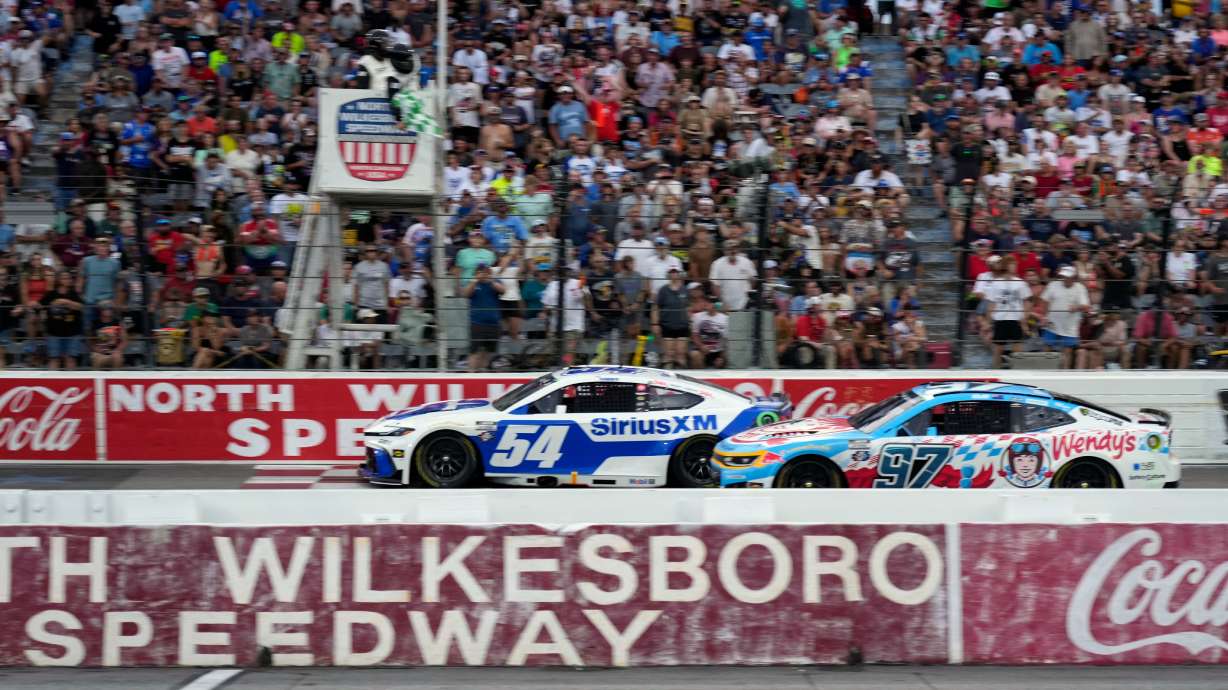 Ty Gibbs (54) passes Shane van Gisbergen (97) to win the first segment of a NASCAR Cup Series auto race in North Wilkesboro, N.C., Sunday, July 19, 2026.
