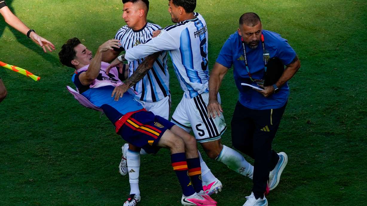 Spain's Gavi, left, falls as he scuffles with Argentina's Leandro Paredes (5) and Thiago Almada during the World Cup final soccer match between Spain and Argentina in East Rutherford, N.J., near New York, Sunday, July 19, 2026.