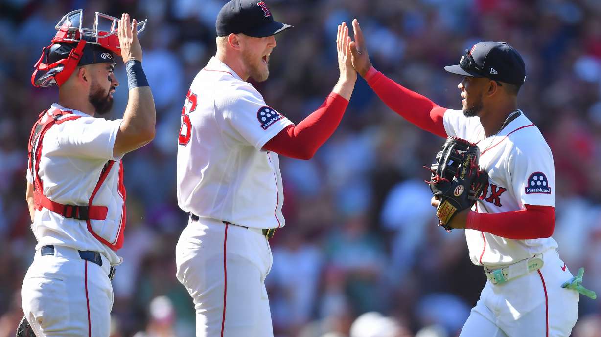 Boston Red Sox's Connor Wong, left, Ryan Watson, center, and Ceddanne Rafaela, right, celebrate after their team's win over the Tampa Bay Rays in a baseball game, Sunday, July 19, 2026, in Boston.