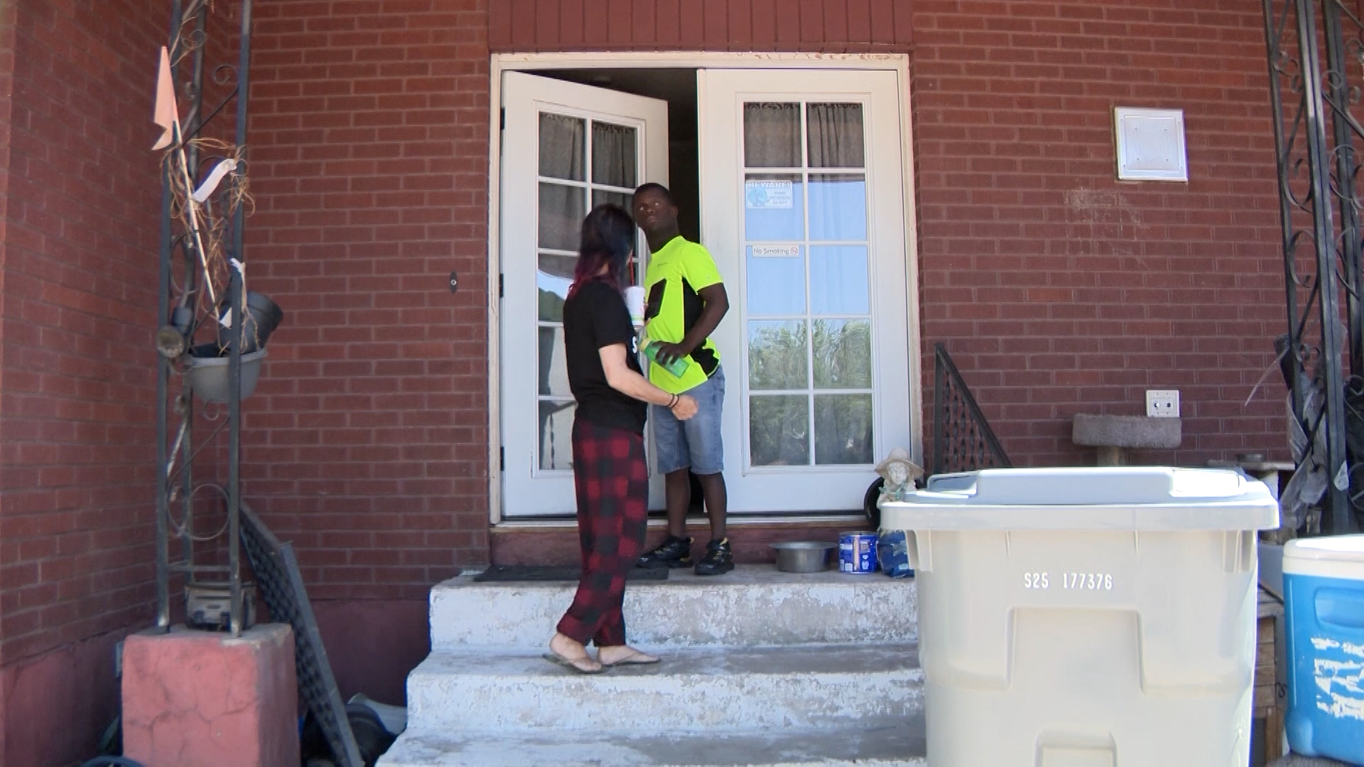 Tammy Teeples walks downstairs with her client, who she said learned to use the handrail independently.