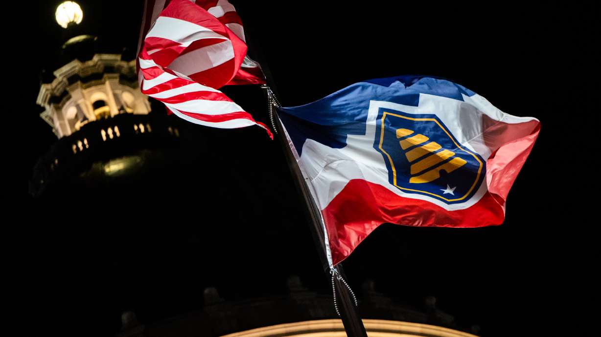 The American flag and Utah's state flag outside the Capitol in Salt Lake City on March 6. Utah has a lower rate of people under "correctional control" than much of the nation but spends more per inmate each year compared with neighboring states, according to a new report.