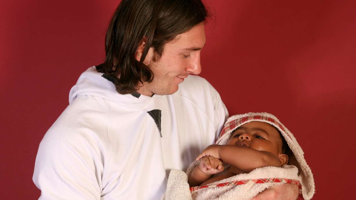 20-year-old soccer star Lionel Messi cradles Lamine Yamal, who was merely six months old at the time during a photo session in Sept. 2007 in the dressing room of the Camp Nou stadium in Barcelona, Spain.