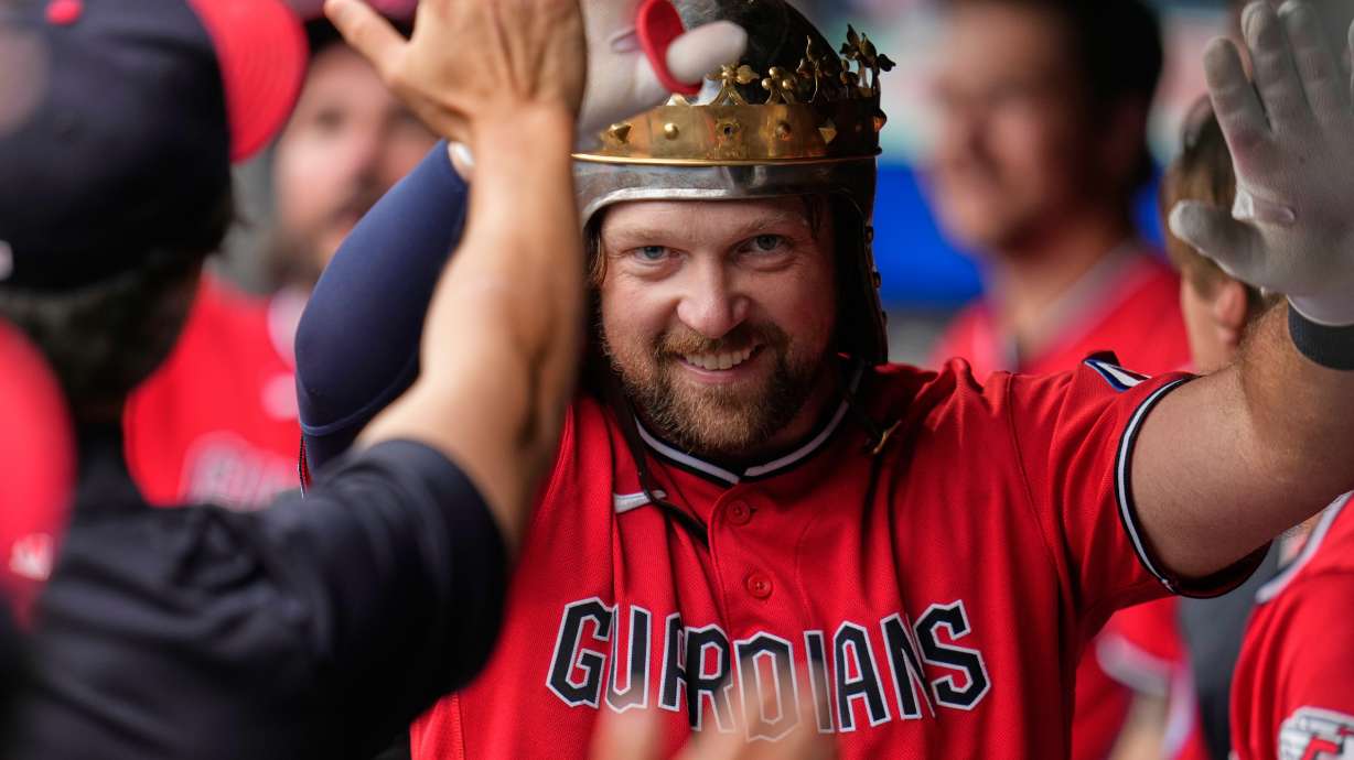 Cleveland Guardians' Rhys Hoskins celebrates in the dugout after hitting a home run in the first inning of a baseball game against the Minnesota Twins in Cleveland, Monday, July 20, 2026.