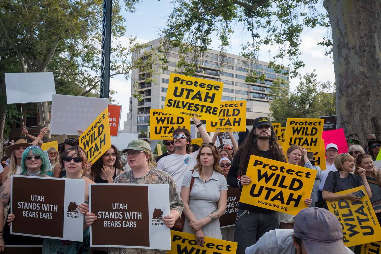 People hold signs and chant during a protest about the reduction of Bears Ears and Grand Staircase-Escalante national monuments outside of the Utah Governor's Mansion in Salt Lake City on Monday.
