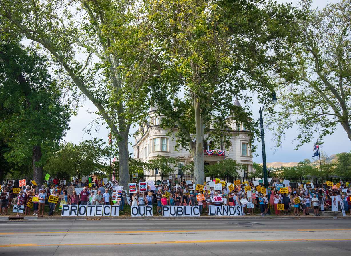 People protest the reduction of Bears Ears and Grand Staircase-Escalante national monuments outside of the Utah Governor's Mansion in Salt Lake City on Monday.