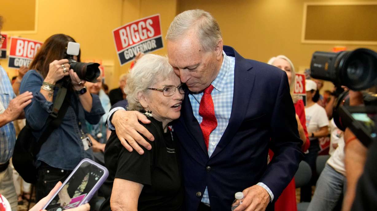 Rep. Andy Biggs, R-Ariz., who is running in the primary for Arizona governor, hugs a supporter at a campaign event, Friday, in Gilbert, Ariz. The GOP is looking to return to power in the battleground state it used to dominate.