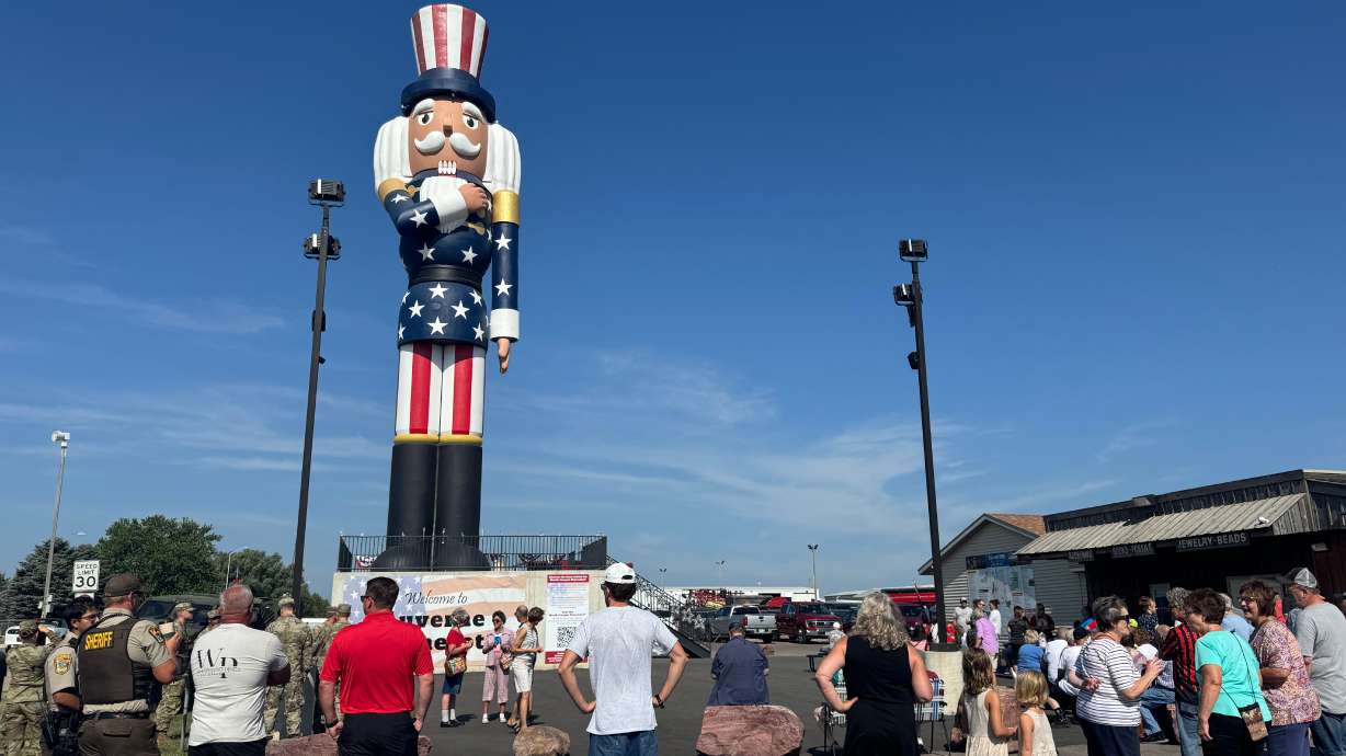 People gather for the ribbon-cutting ceremony for Verne the Patriot in Luverne, Minnesota, Saturday. The nearly 66-foot tall statue was built by Ogden-based company WhiteClouds.
