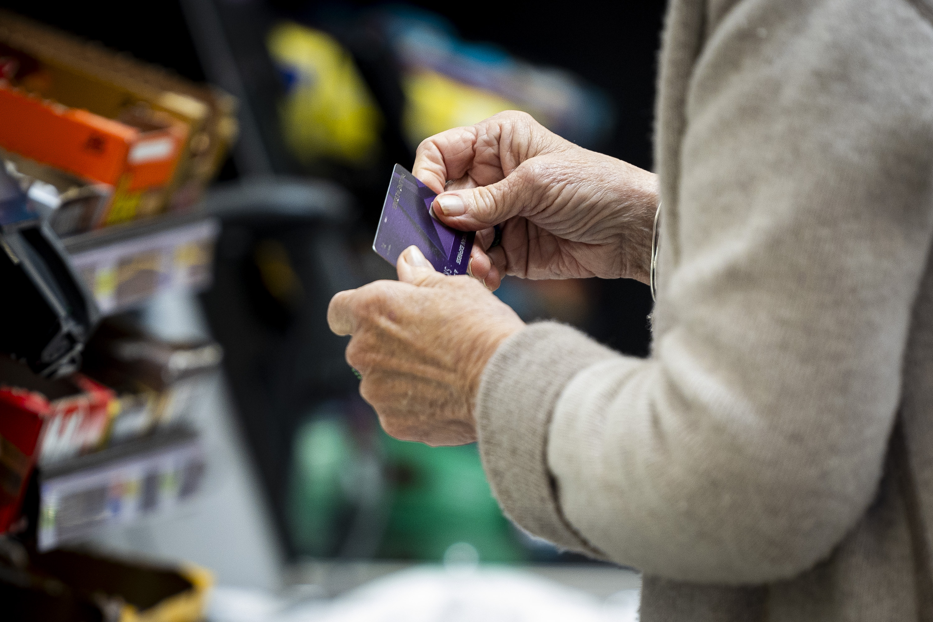 A shopper uses a credit card at Dan's Market in Salt Lake City on Oct. 8. An increasing number of Utahns are on the hook for consumer debt, according to a new report.