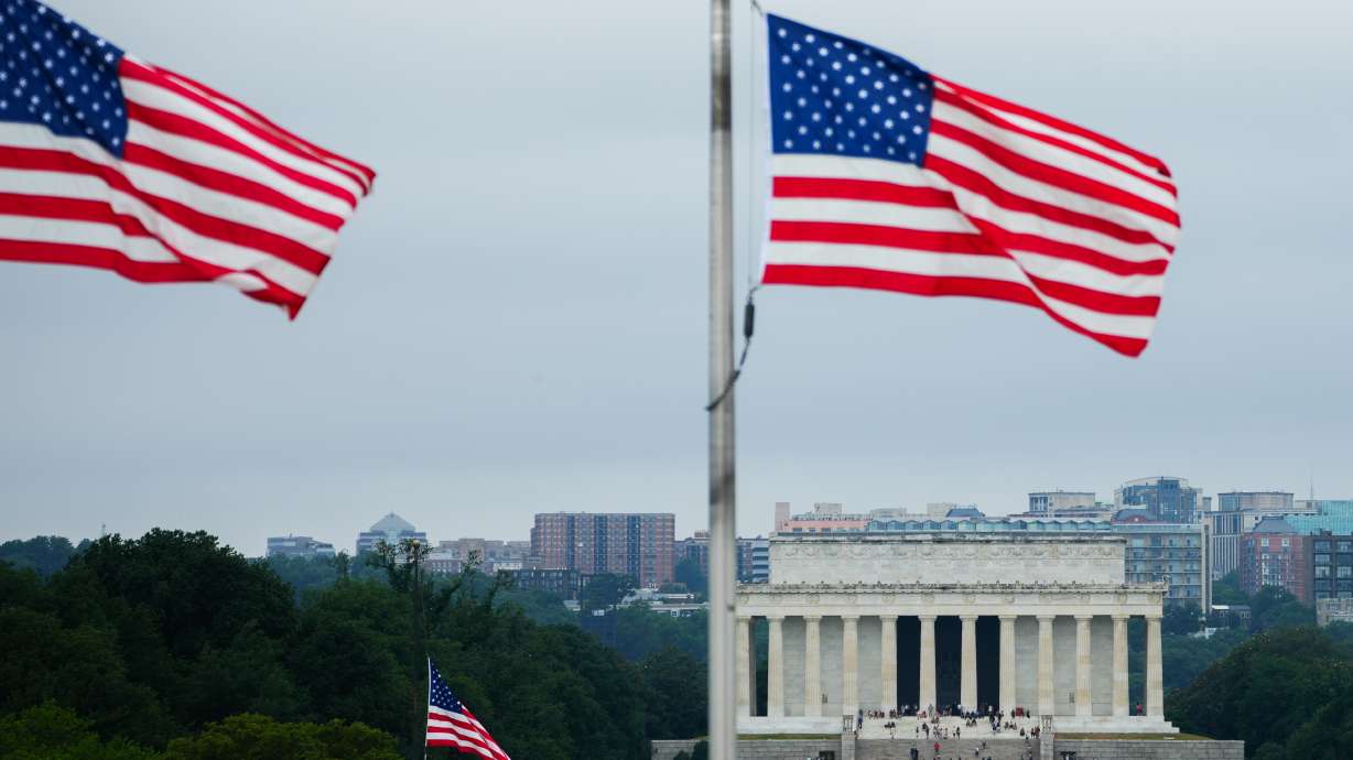 American flags fly above the Lincoln Memorial, Thursday, July 9, in Washington. The U.S. military has confirmed that a third service member is believed to be dead in Friday's attack on a base in Jordan and identified them as Sgt. Angel S. Rampersad, 28, of Ozone Park, New York.
