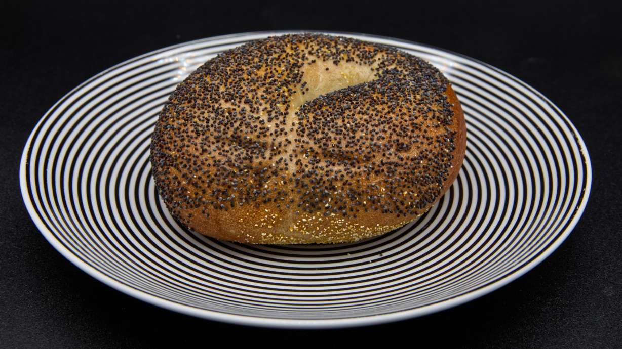 A poppy seed bagel on a plate photographed in Phoenix, Ariz., Monday. What started as a Jewish immigrant food has now become an American breakfast staple.