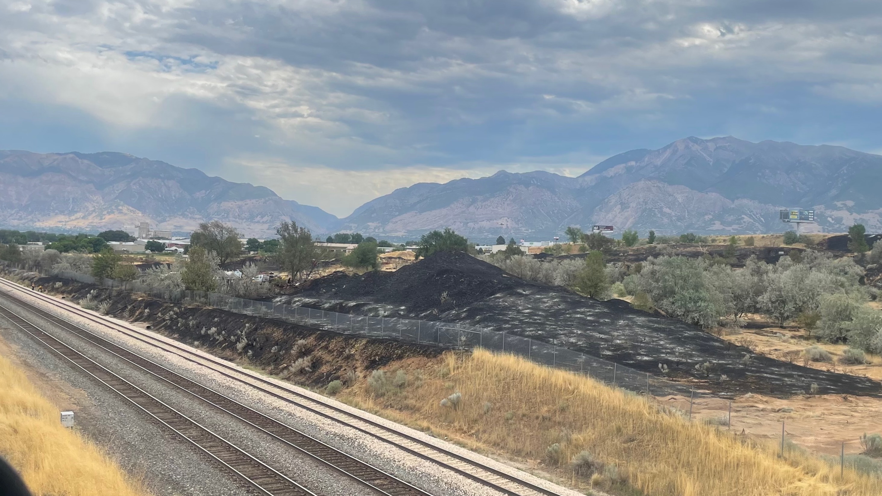 A day after the fire on Monday along a rail corridor shared by Utah Transit Authority and Union Pacific that torched three homes, debate lingers over the cause. One of the impacted areas west of Hinckley Drive is pictured on Tuesday.