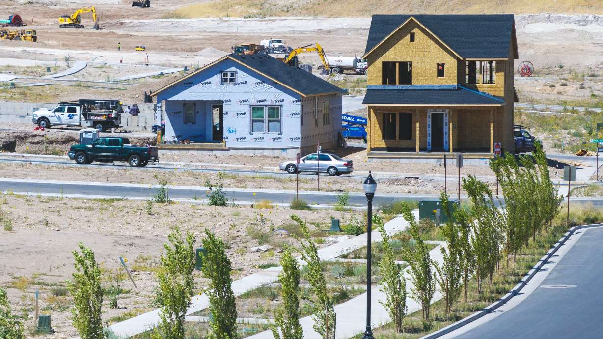 Workers build homes in West Jordan on Aug. 11, 2025. Mortgage rates would have to drop below 3% to put a median-priced home in reach for many Utahns, a new analysis found.