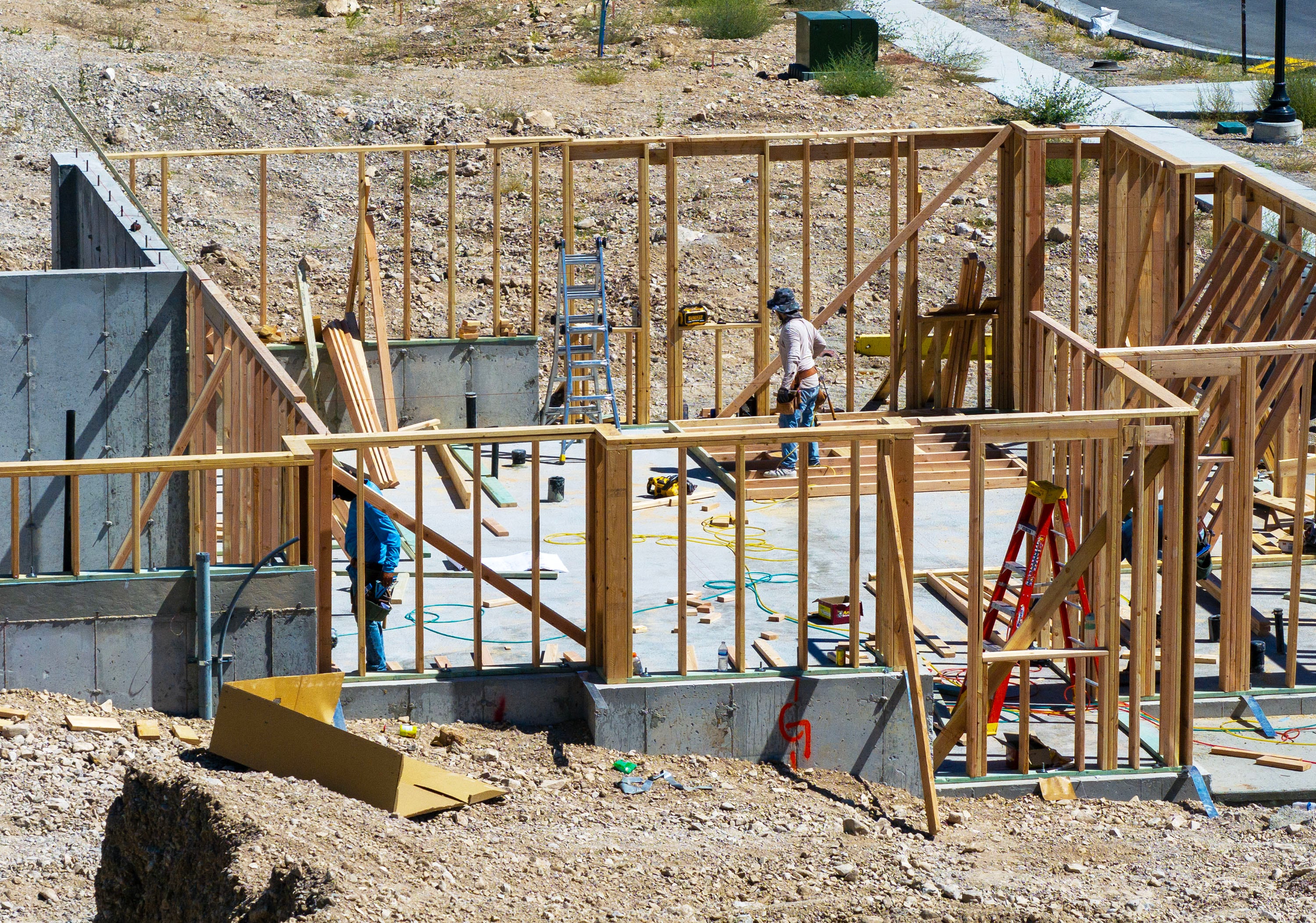 Workers build homes in West Jordan on Aug. 11, 2025. A new analysis found mortgage rates must fall below 3% for Utahns to even afford a home.