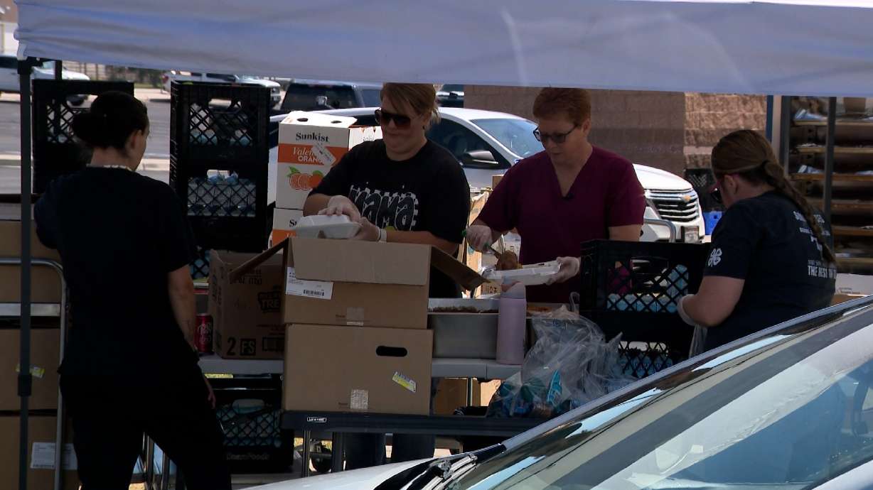 School employees in Beaver pass out meals on Tuesday. Not having water has made things complicated for Beaver County School District employees who feed hundreds of children during the summer, but quitting was never an option.