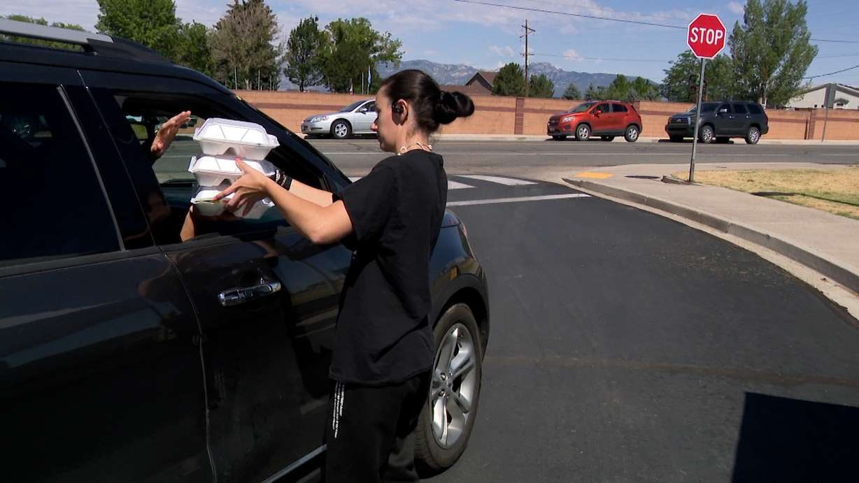 School employees in Beaver pass out meals on Tuesday.