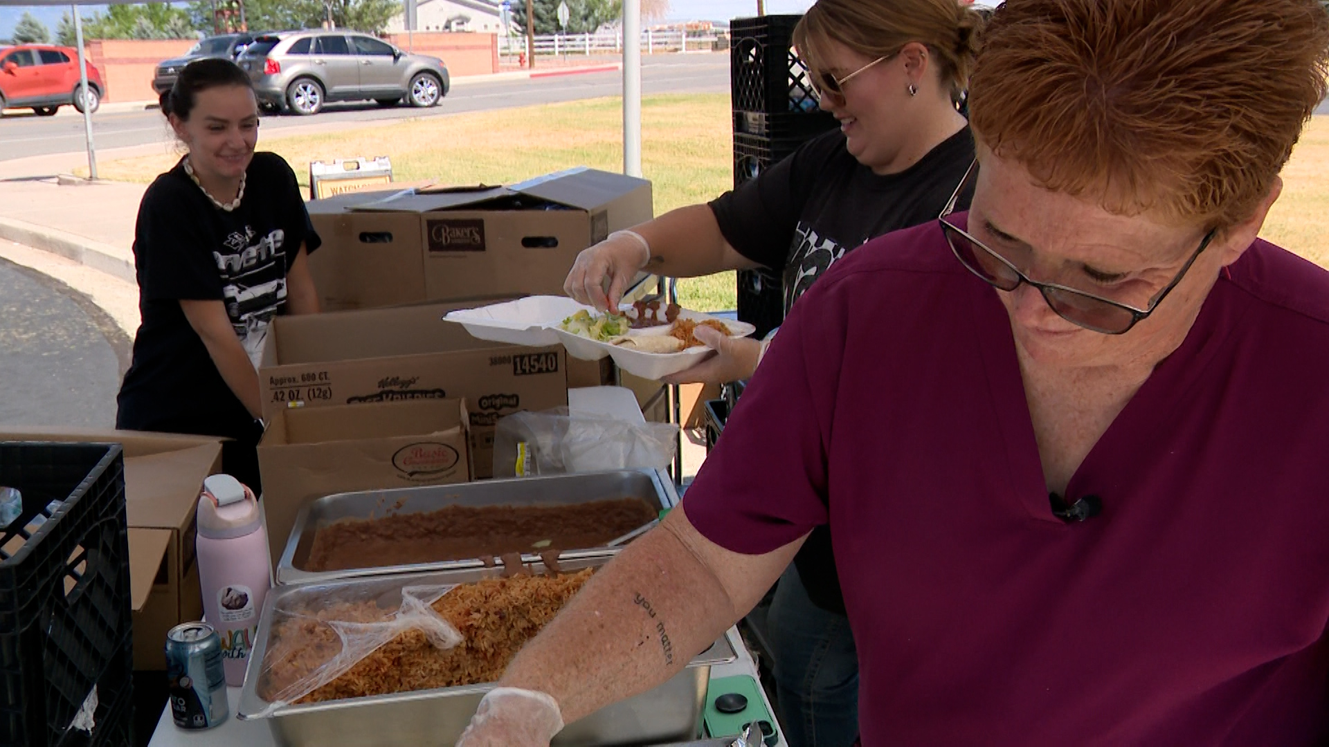 Trina Robinson, right, and other Beaver County School District employees prepare meals to pass out on Tuesday.