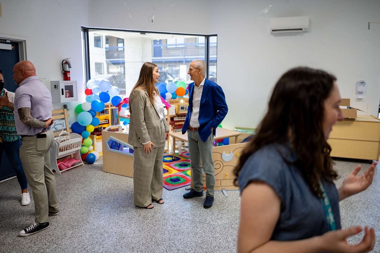 Lily Ward, Utah Office of Homeless Services program manager, center left, speaks with Wayne Niederhauser, board member for Shelter the Homeless and former Utah state Homeless Coordinator, center right, after first lady Abby Cox read to children and promoted early literacy at The FINCH (Family Interim Noncongregate Housing), operated by The Road Home, in South Salt Lake on Tuesday.