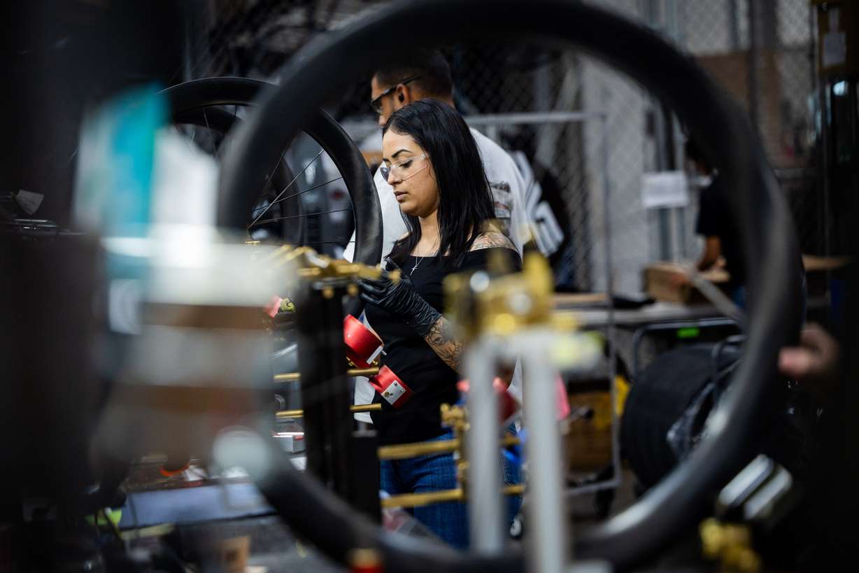 Roxana Barboza works on the wheel build at the ENVE Composites factory in Ogden on July 17.