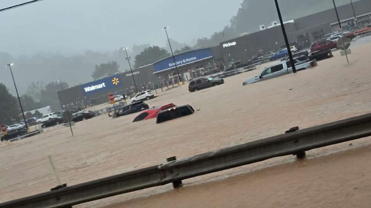 In this photo provided by Alexis Wood, a flooded Walmart parking lot is shown Tuesday in Weston, W.Va.