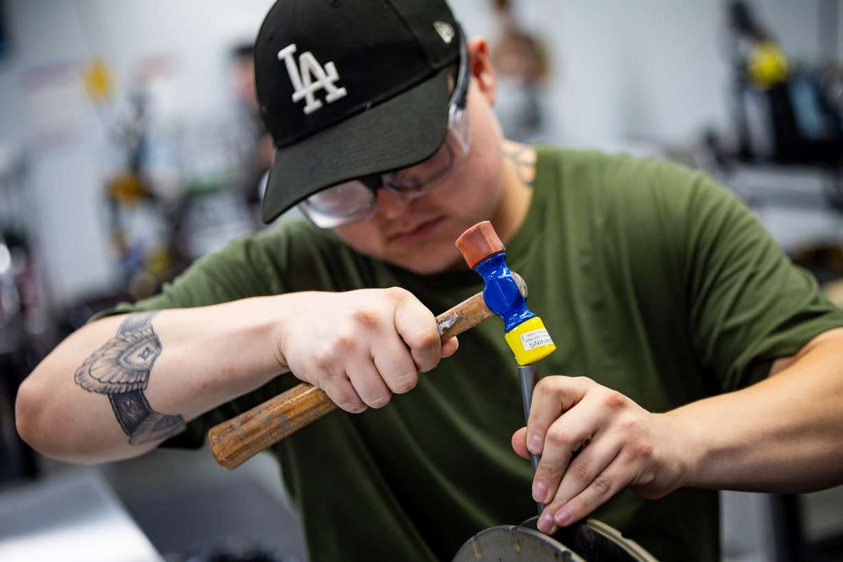 Lay up technician Alexander Velazquez works on putting the rim together at the ENVE Composites factory in Ogden on July 17.
