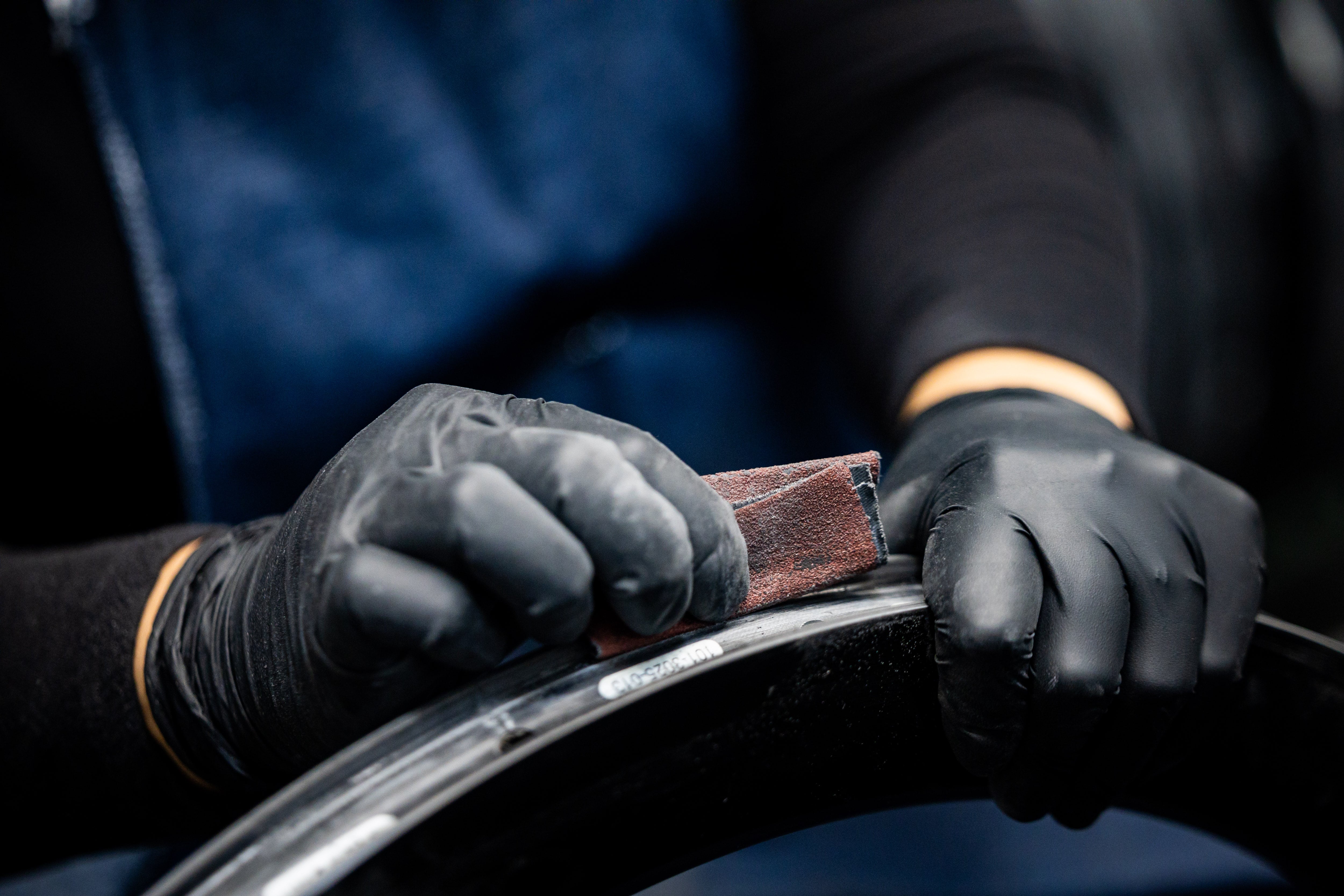 A quality control employee brushes a rim at the ENVE Composites factory in Ogden on July 17.