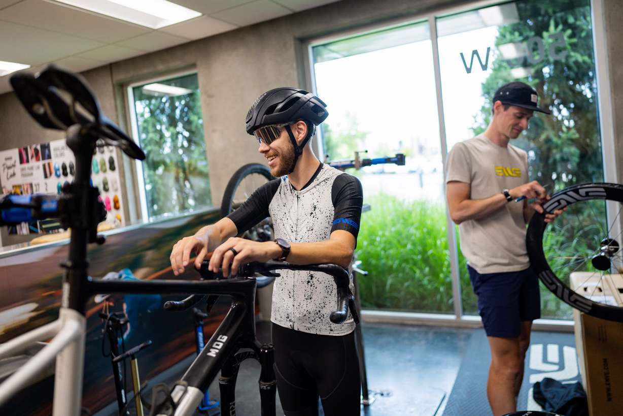 Tryston Klein, material handling employee, left, prepares to go on a bike ride on his hour-long lunch break at the ENVE Composites factory in Ogden on July 17.