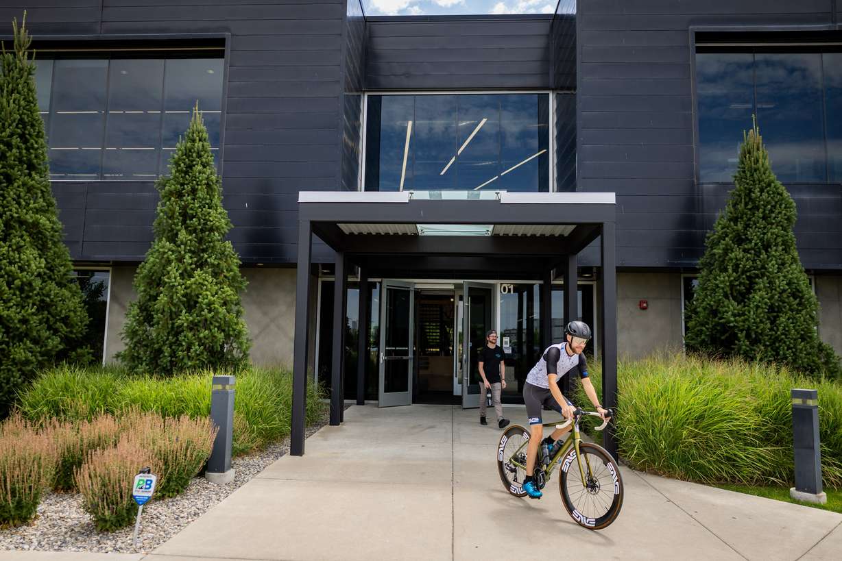 Tryston Klein, material handling employee, leaves on a bike ride on his hour-long lunch break at the ENVE Composites factory in Ogden on July 17.