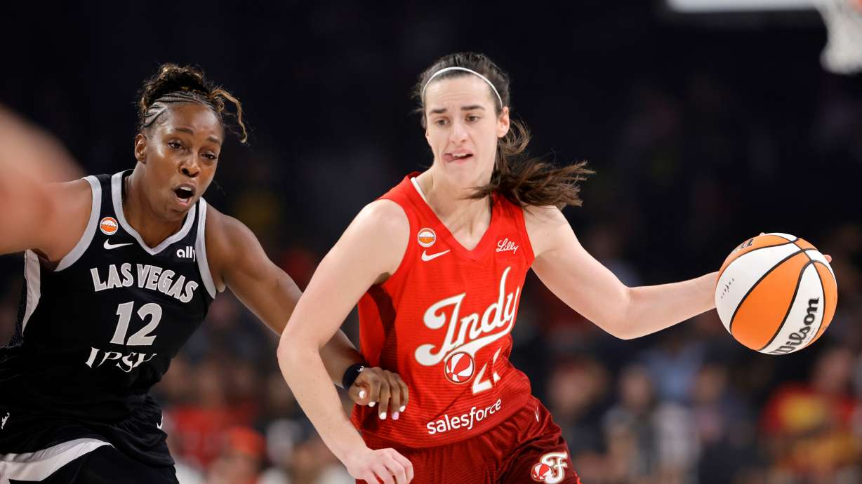 Indiana Fever guard Caitlin Clark (22) drives against Las Vegas Aces guard Chelsea Gray (12) during the first half of a WNBA basketball game Sunday, July 12, 2026, in Las Vegas.