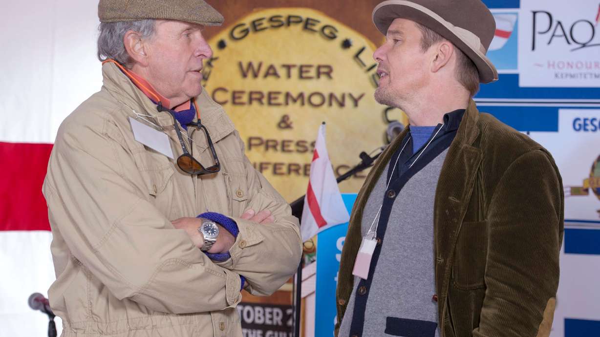 FILE - Actor Ethan Hawke, right, talks with Charles Gaines as they attend the Mi'kmaq community's water ceremony on the shores of Pomquet Harbour to support the aboriginal call for a moratorium on oil and gas exploration in the Gulf of St. Lawrence, near Antigonish, Nova Scotia, on Oct. 26, 2015.