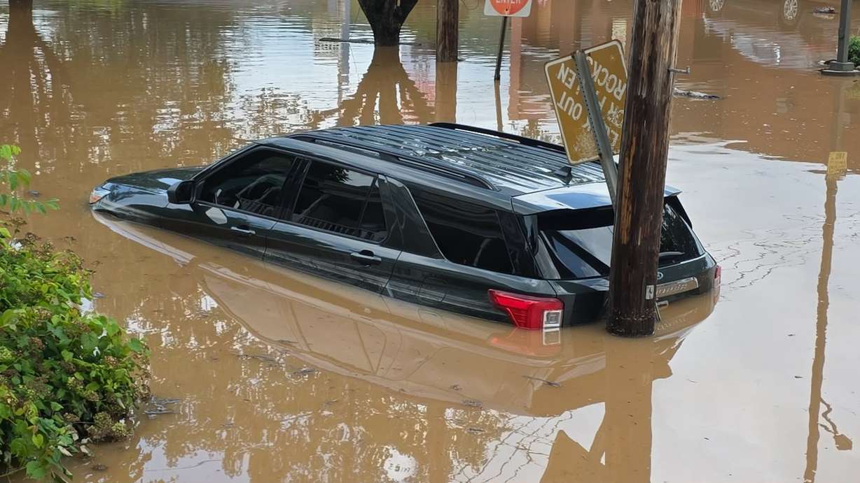 A vehicle sits half-submerged in floodwaters in Buckhannon, W.Va., on Wednesday.