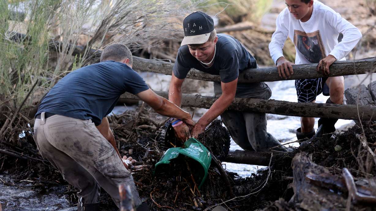 Dray Smith, Krosby Hollingshead and Lincoln Smith clear debris that washed downstream so flood waters can flow freely after flooding in Beaver on Monday. Gov. Spencer Cox issued a state of emergency on Wednesday over the flooding in Beaver and two other Utah counties.