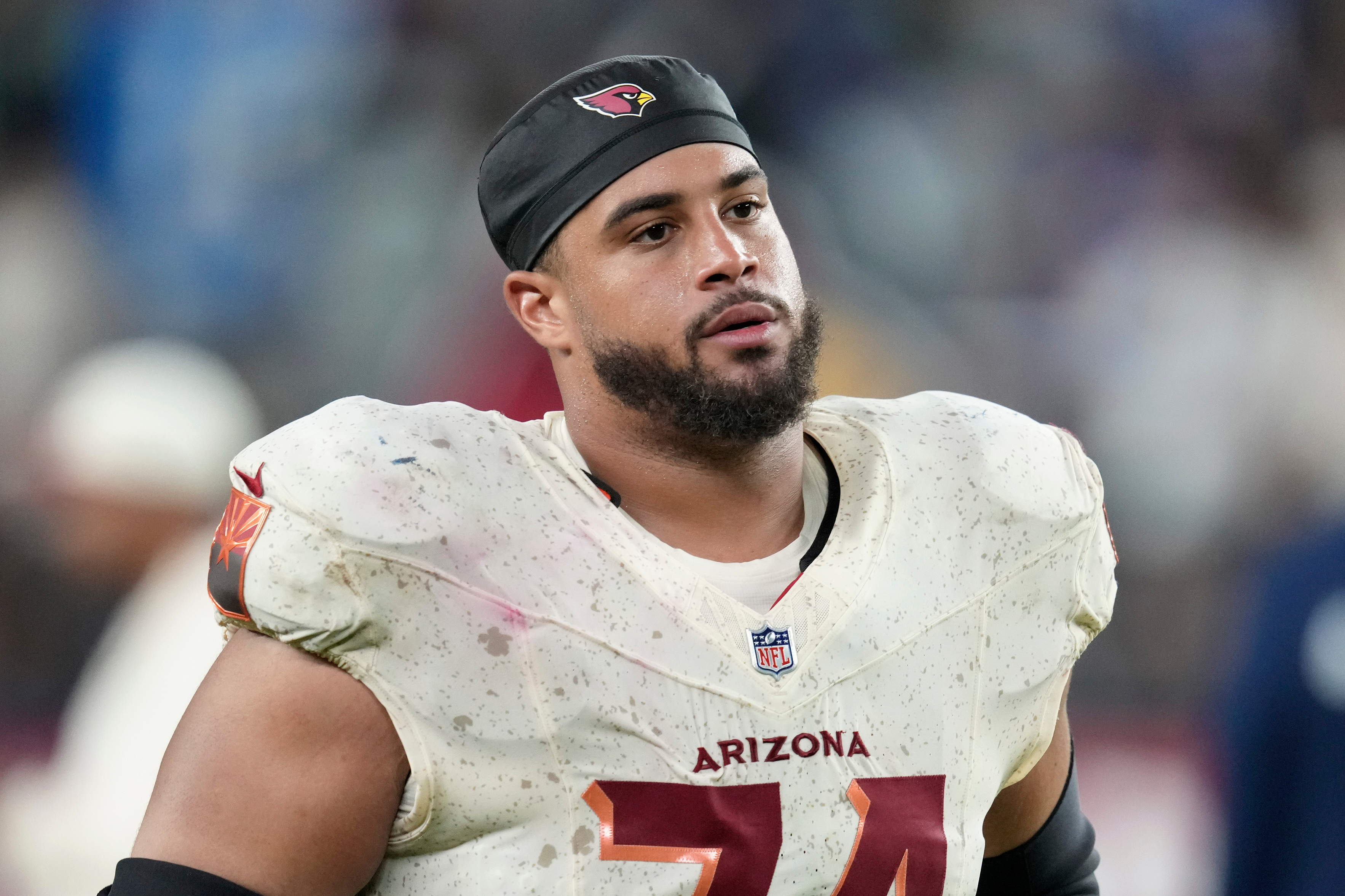 FILE - Arizona Cardinals guard Isaiah Adams walks off the field after an NFL football game against the Seattle Seahawks, Sept. 25, 2025, in Glendale, Ariz. 