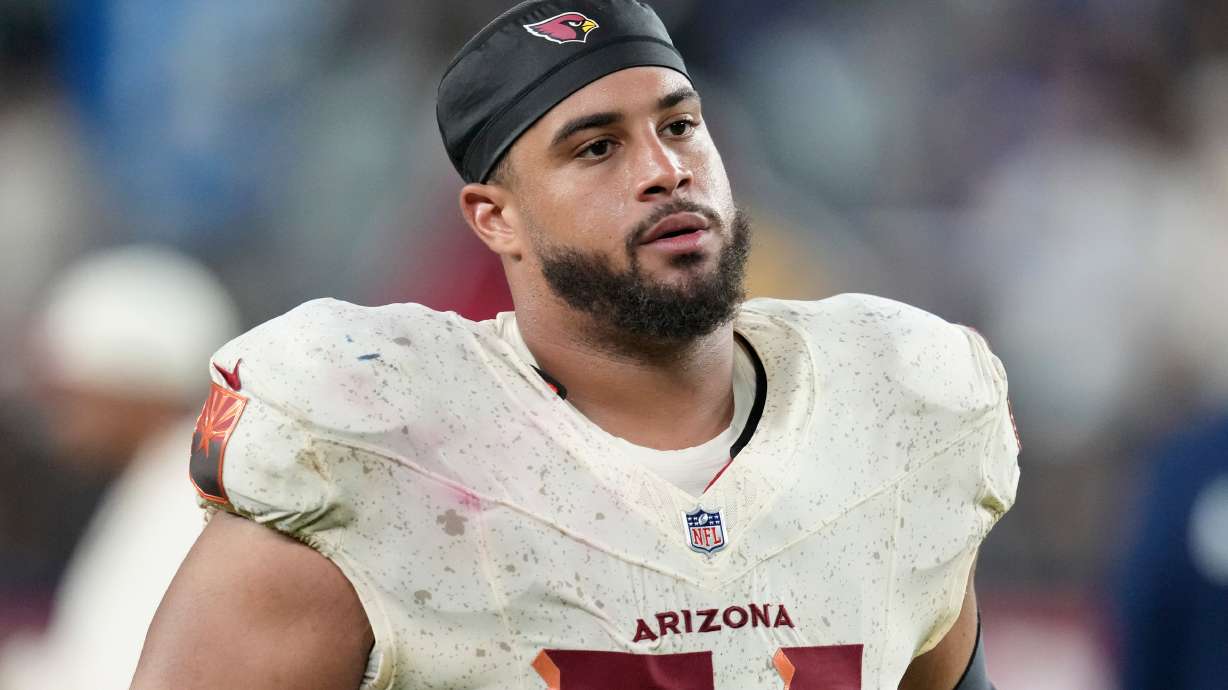 FILE - Arizona Cardinals guard Isaiah Adams walks off the field after an NFL football game against the Seattle Seahawks, Sept. 25, 2025, in Glendale, Ariz.
