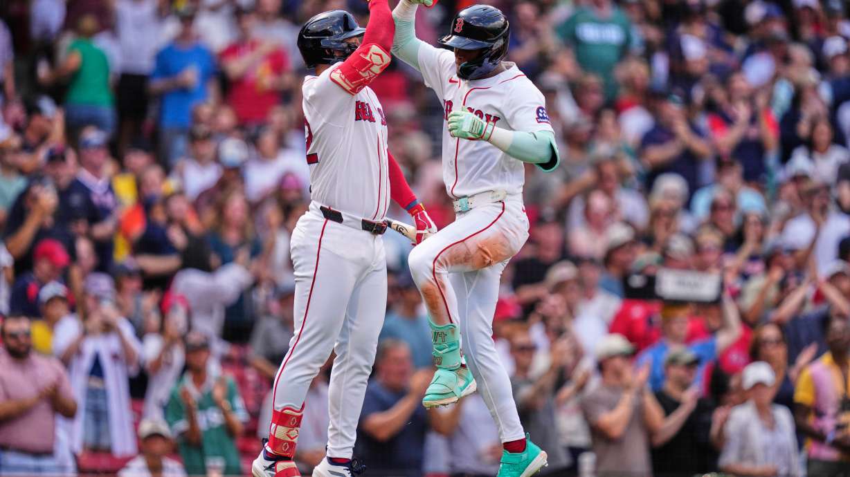 Boston Red Sox's Ceddanne Rafaela, right, is congratulated by Wilyer Abreu after hitting a solo home run in the fourth inning during the first baseball game of a doubleheader against the Baltimore Orioles, Wednesday, July 22, 2026, in Boston.