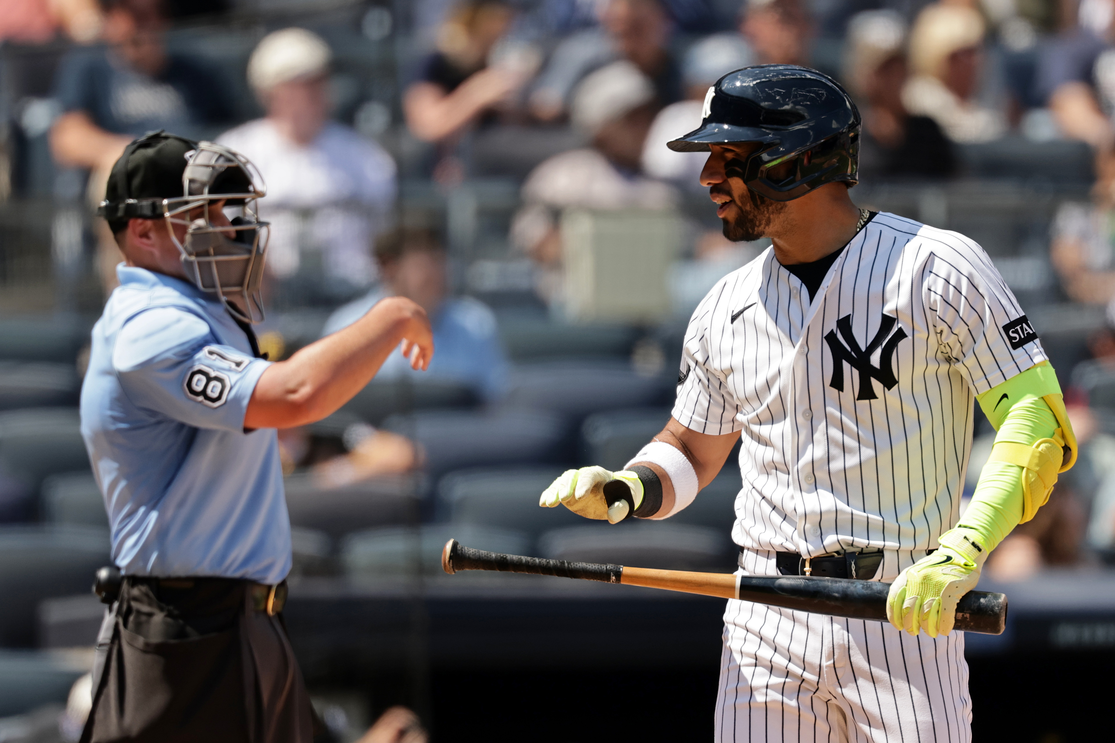 New York Yankees' José Caballero reacts after striking out in front of home plate umpire Quinn Wolcott (81) in the sixth inning during the first baseball game of a doubleheader against the Pittsburgh Pirates, Wednesday, July 22, 2026, in New York. 