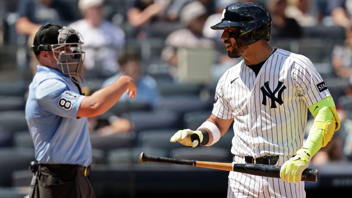 New York Yankees' José Caballero reacts after striking out in front of home plate umpire Quinn Wolcott (81) in the sixth inning during the first baseball game of a doubleheader against the Pittsburgh Pirates, Wednesday, July 22, 2026, in New York.