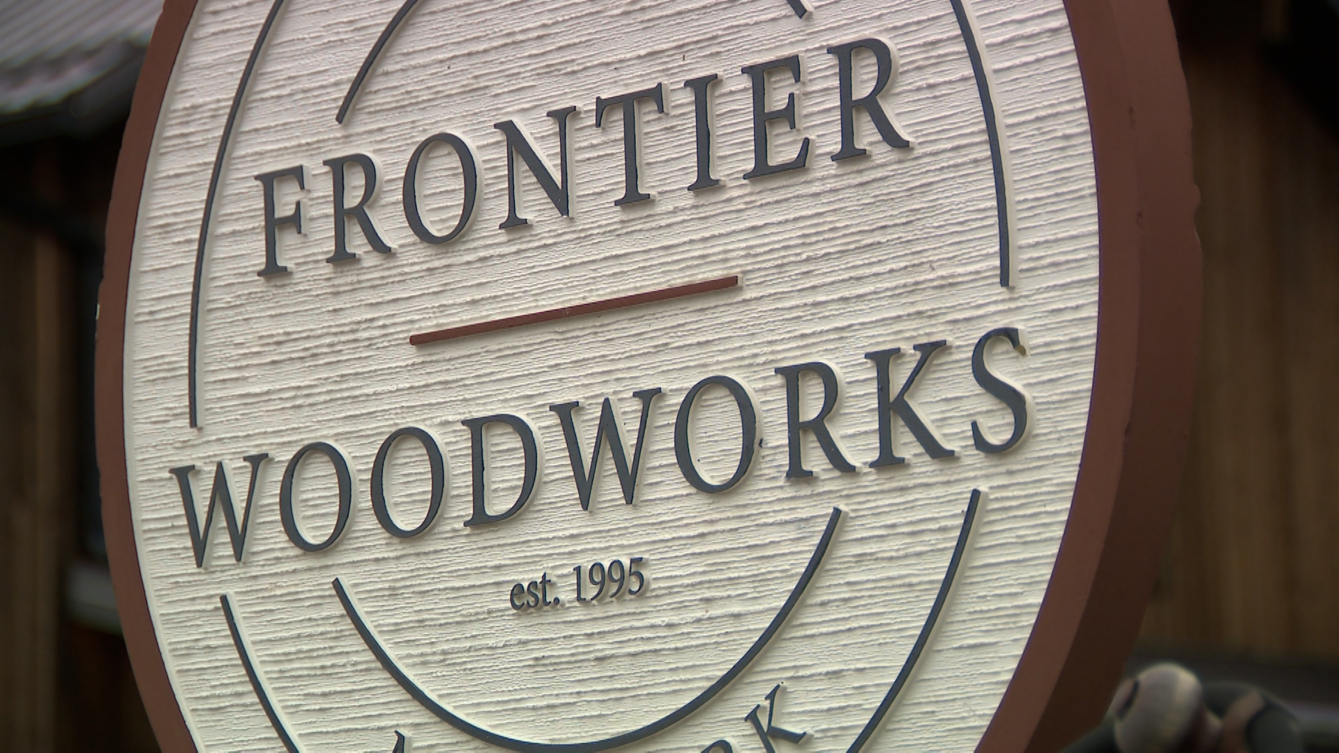 The Frontier Woodworks sign is pictured on Wednesday.