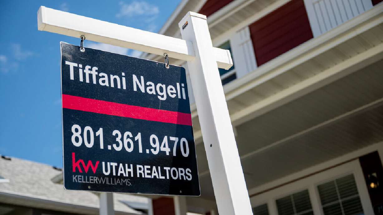 A for-sale sign stands in front of a home in West Jordan on May 12. Salt Lake County has hit a new record when it comes to housing prices.