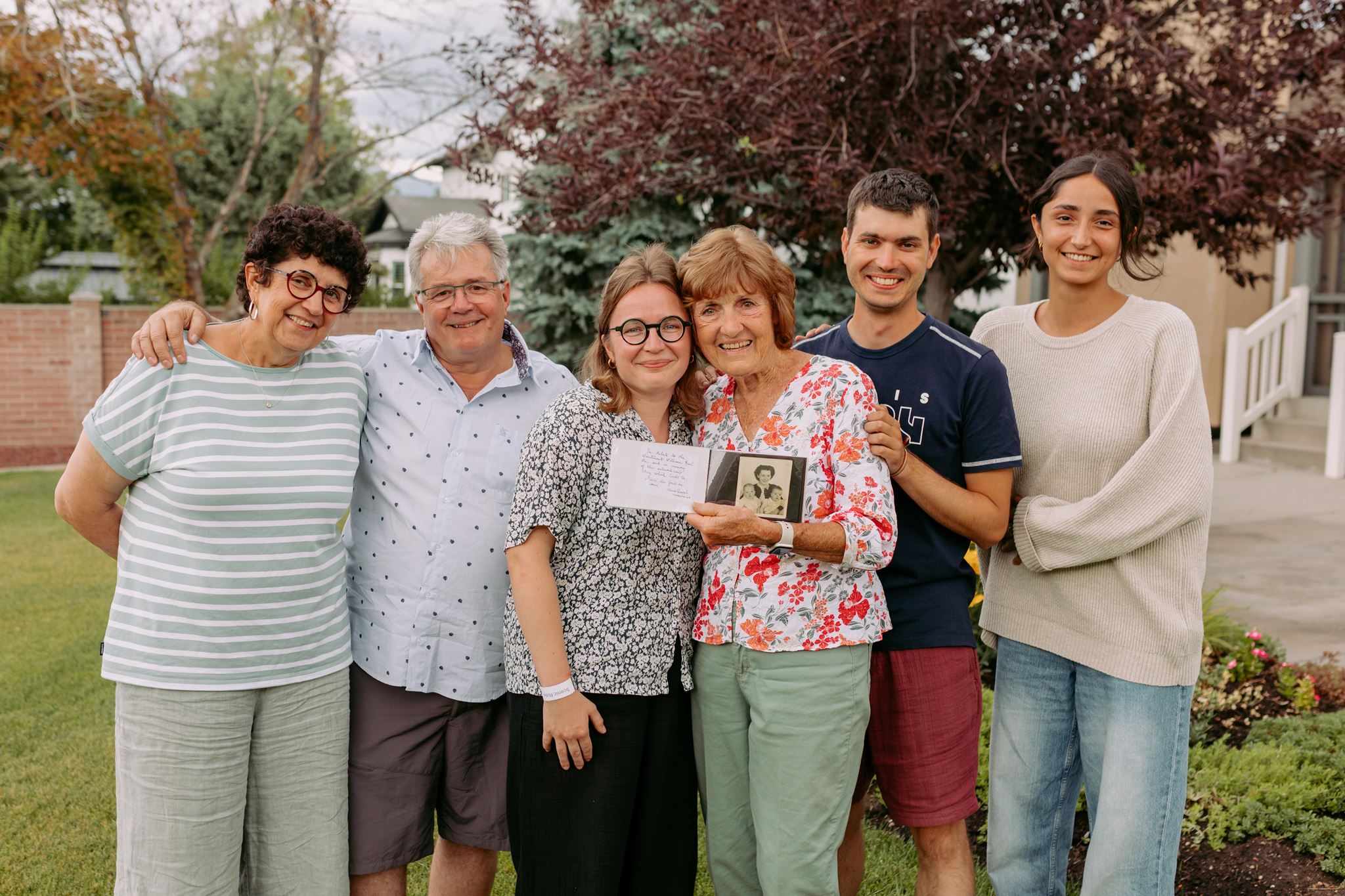 Patricia Richter holds a photo album in South Jordan on July 17 with the Duval family. The album has photographs from Richter's father that Marie Duval's grandmother found during World War II in Normandy, France.