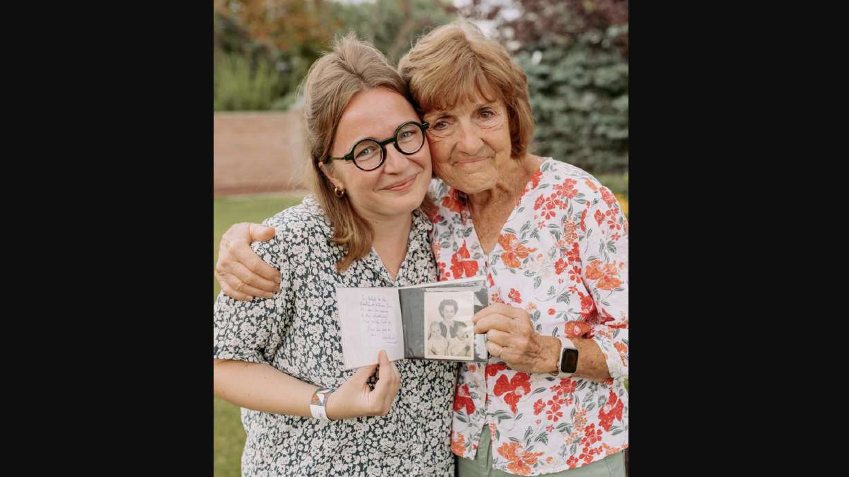 Marie Duval and Patricia Richter hold a photo album in South Jordan on July 17. The photo album has photographs from Richter's father that Duval's grandmother found during World War II in Normandy, France.