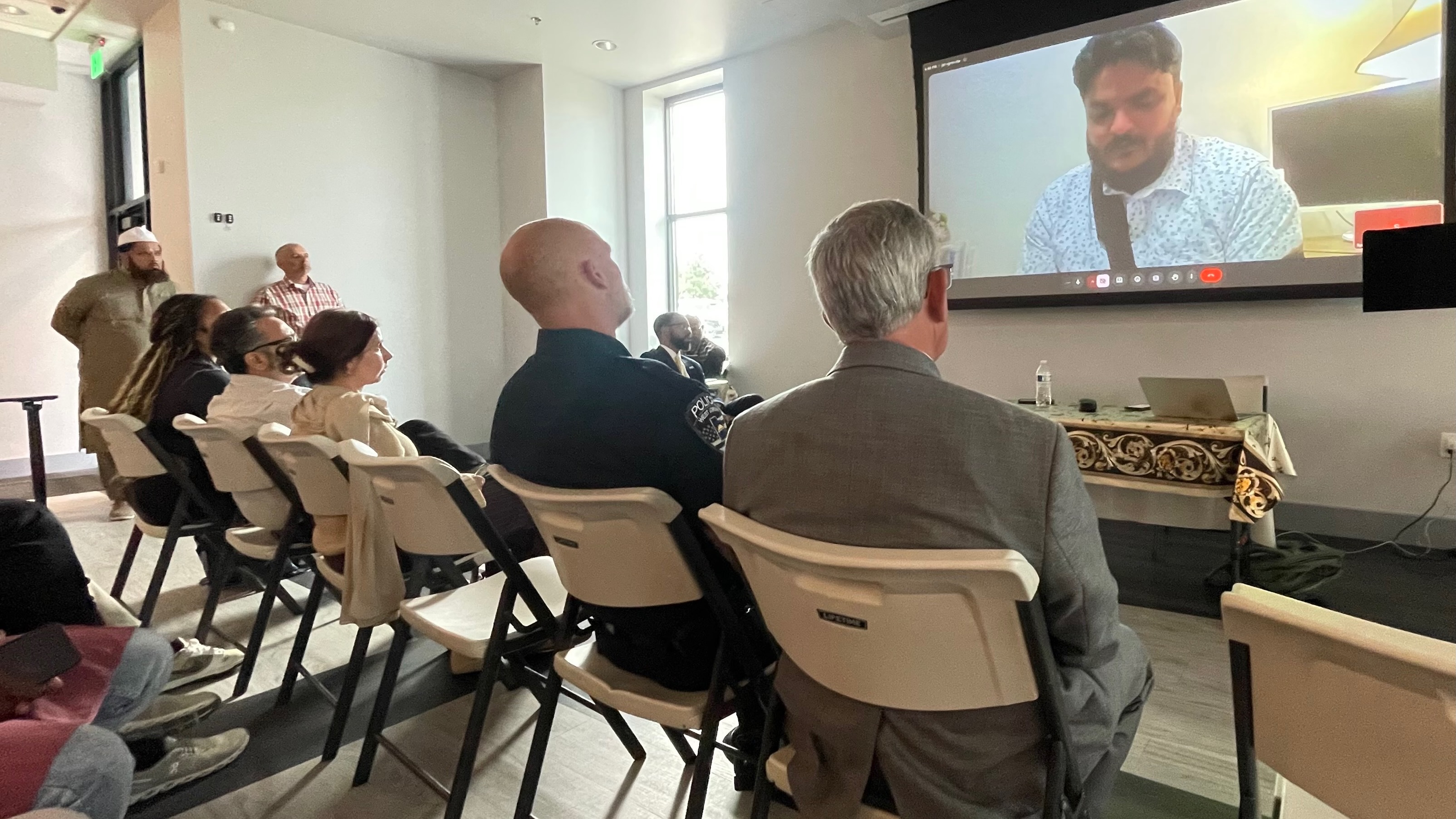 Members of Utah's Muslim community gathered Wednesday as a show of solidarity after an attack last week on a Muslim man, Syed Sohail. Sohail is pictured addressing the gathering via video at the Utah Islamic Center in West Jordan.