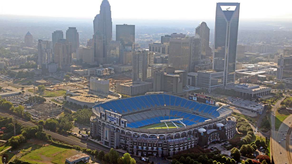 FILE - In this Aug. 16, 2012 file photo, the skyline of Charlotte, N.C., rises behind Bank of America Stadium in this aerial photo.
