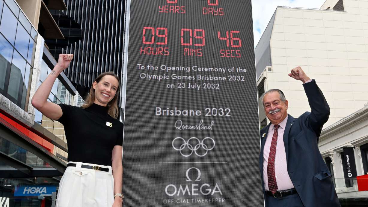 Australian Olympian Emma McKeon, left, and Brisbane 2032 Organising Committee President Andrew Liveris pose at the unveiling of the count-down clock marking six years until the Brisbane 2032 Olympics, in Brisbane, Australia, Thursday, July 23, 2026.